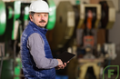 Small factory owner, overlooking machinery